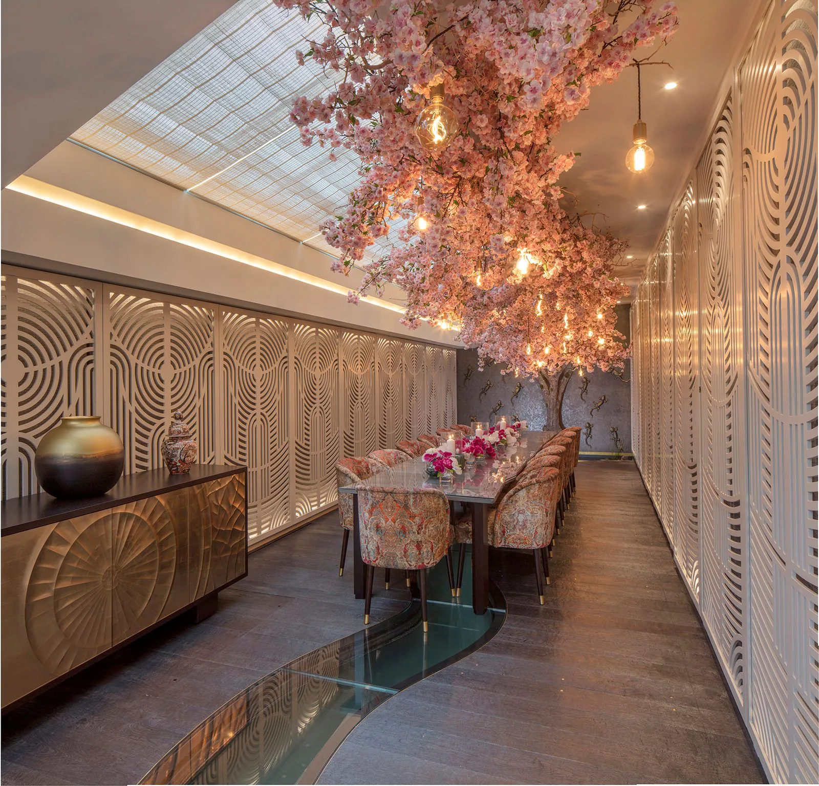 Dining room with decorative screens and statement lighting by NOOR